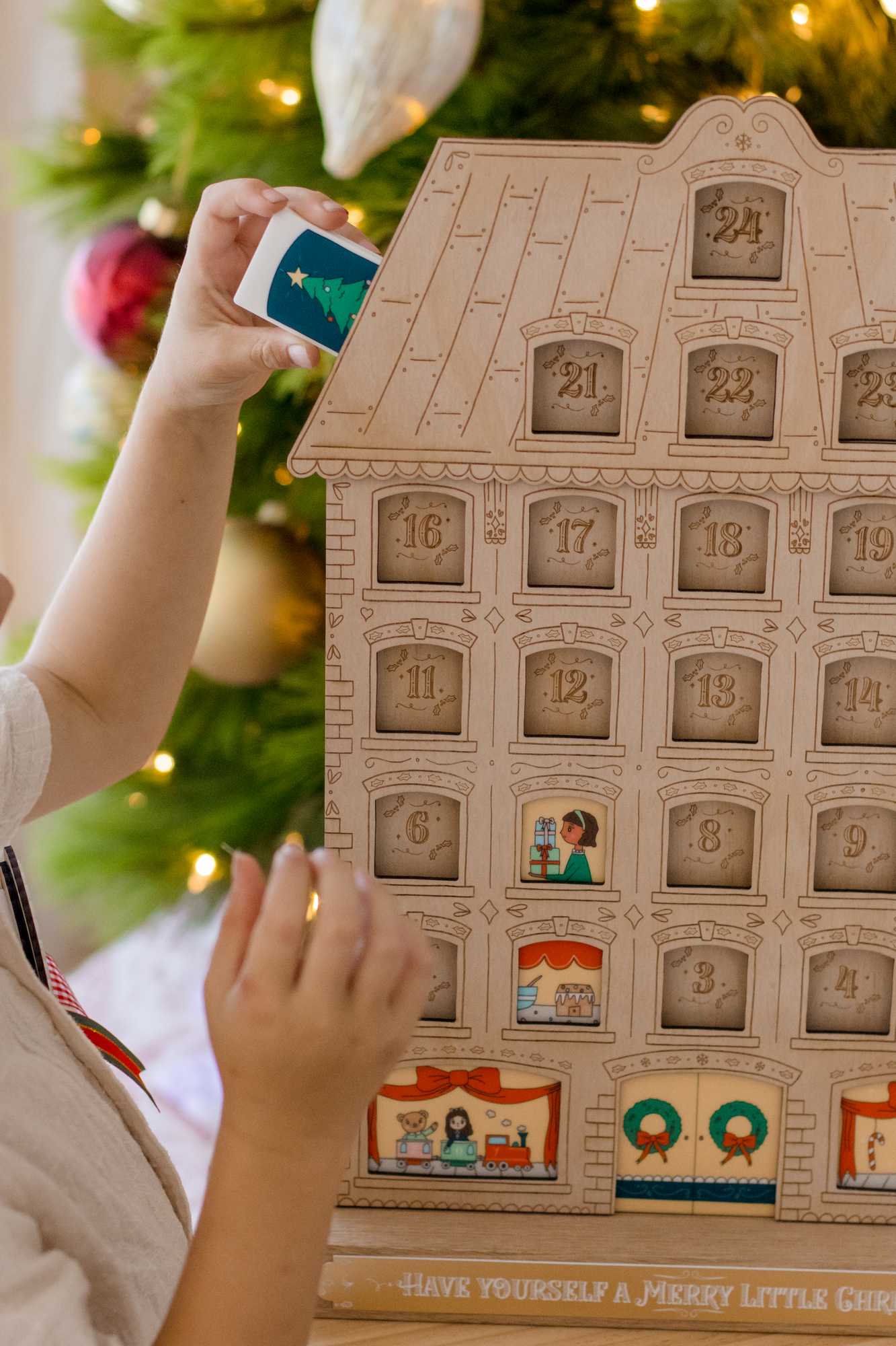 children putting the printed tiles into the festive adent calendar