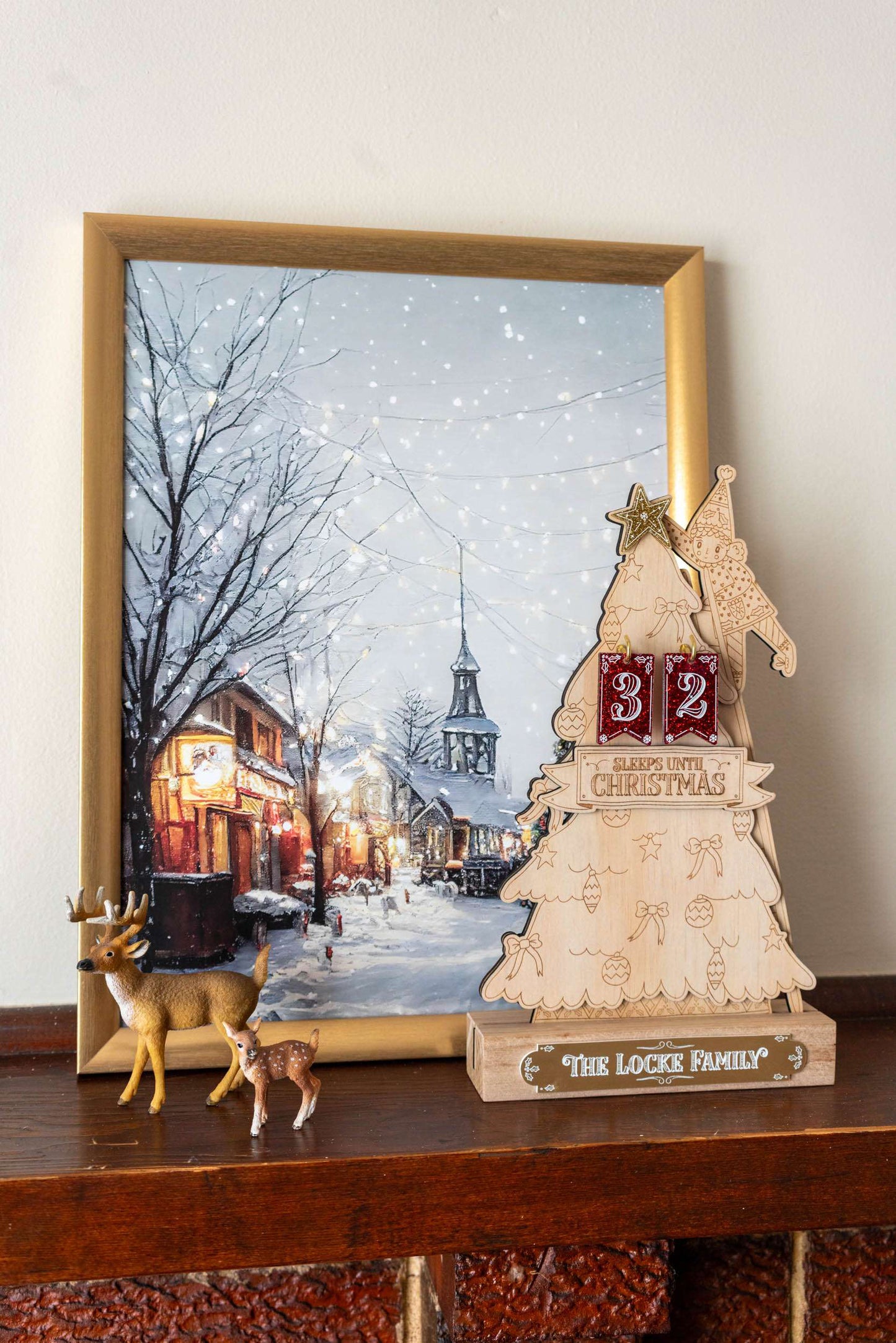 Wooden Jolly Christmas tree advent countdown with snowflake design, against a blurred winter scene background.