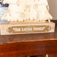 Wooden Christmas tree countdown with 'The Locke Family' engraving on a wooden surface.
