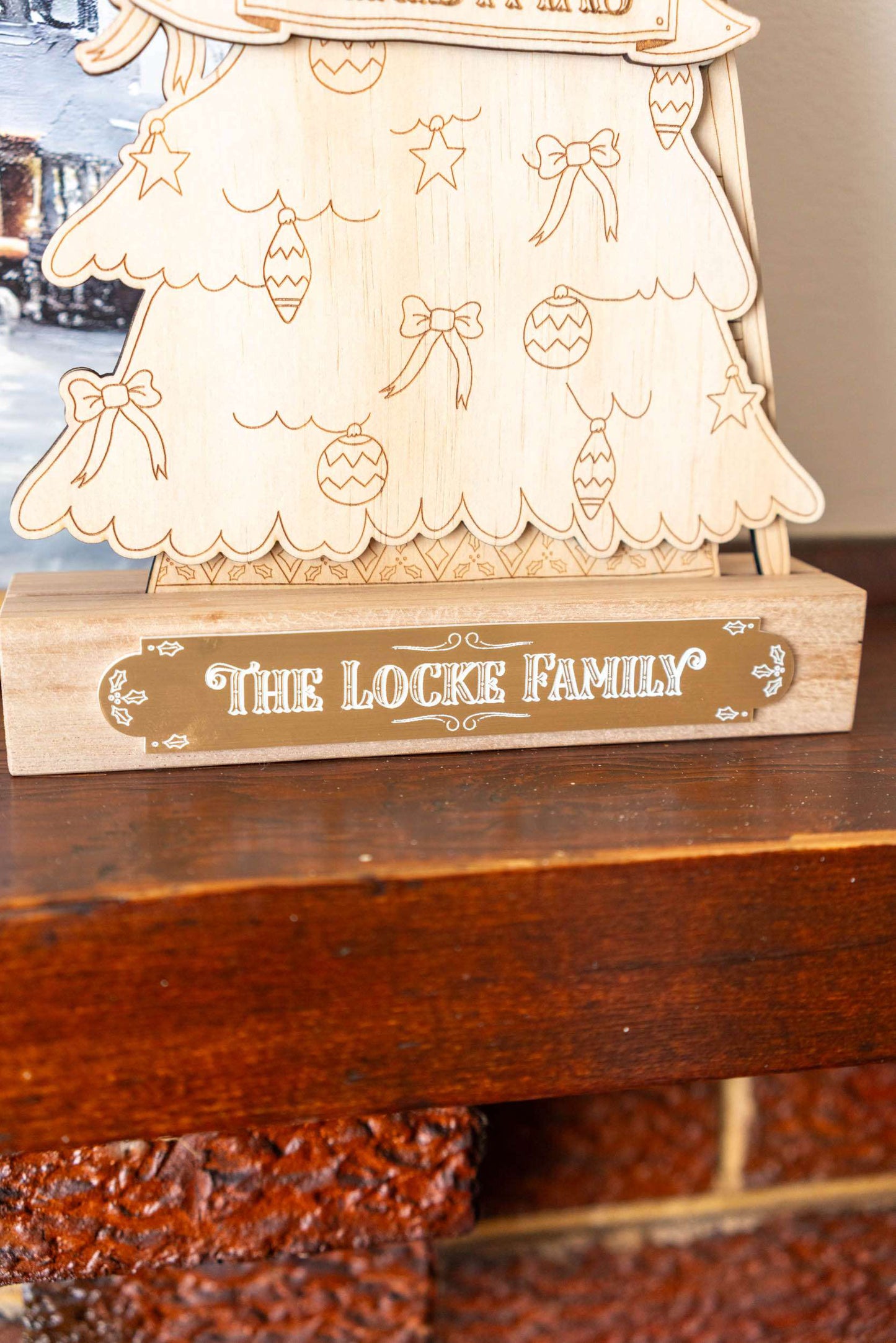 Wooden Christmas tree countdown with 'The Locke Family' engraving on a wooden surface.
