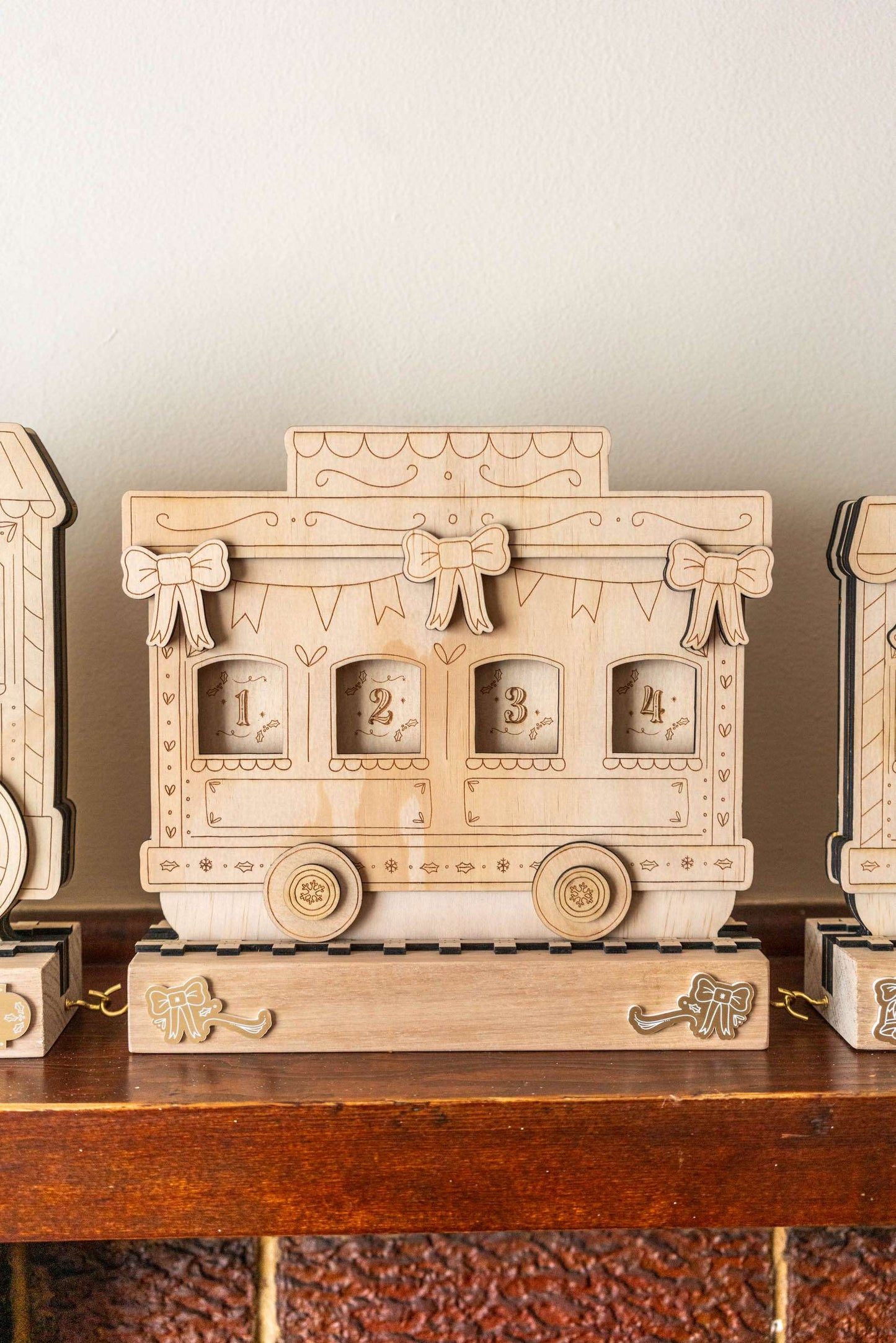 Wooden train advent calendar shaped like a vintage truck on a wooden surface with a neutral background.
