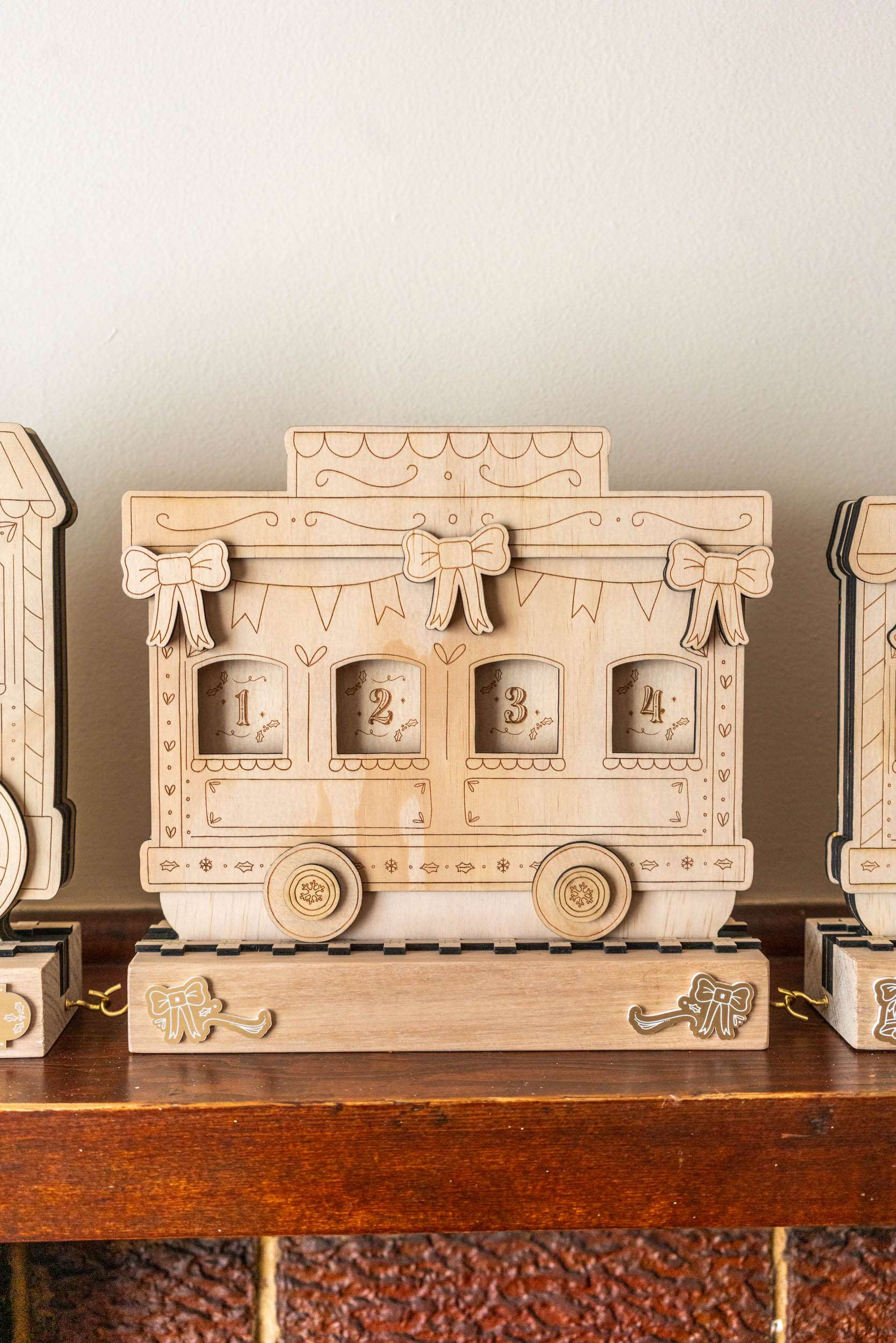 Wooden train advent calendar shaped like a vintage truck on a wooden surface with a neutral background.