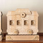 Wooden train advent calendar shaped like a train car on a wooden surface with a neutral background