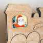 Wooden toy train with a Santa Claus figure inside a window